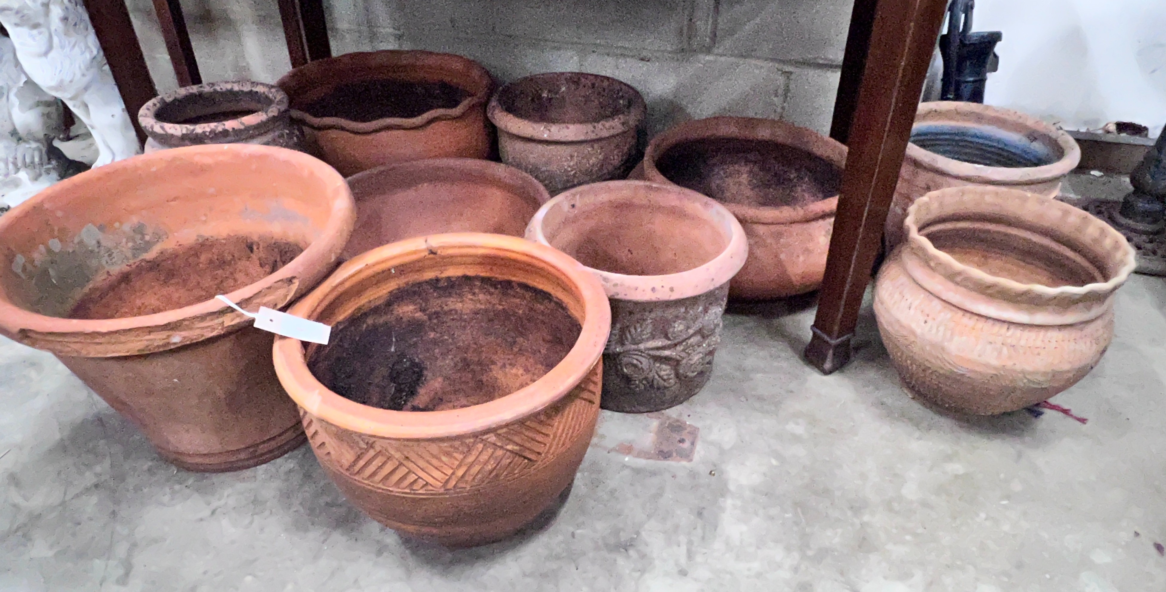 Ten assorted terracotta garden planters, largest diameter 43cm